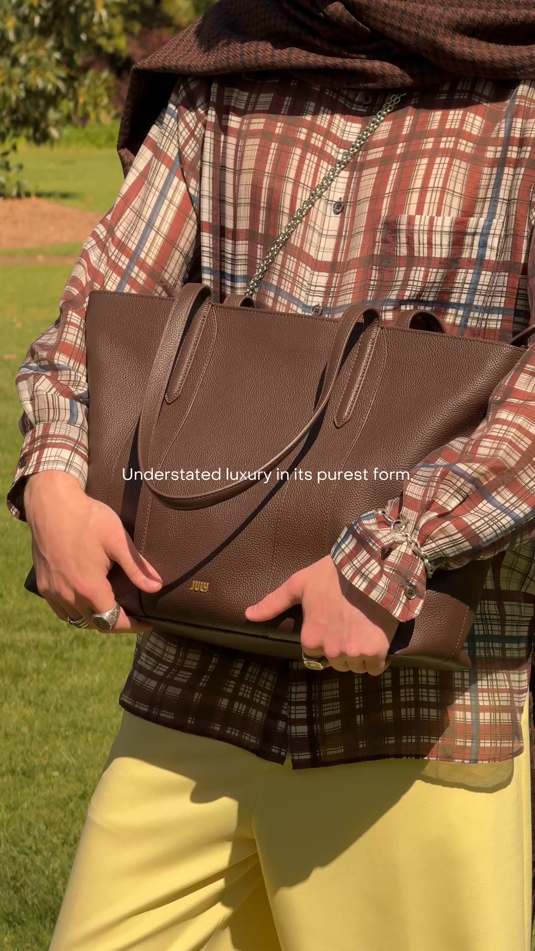 Meet the Eden Large Tote. Crafted in pebbled leather with gold hardware, it's the bag that looks just as good on your shoulder as it does on your luggage.