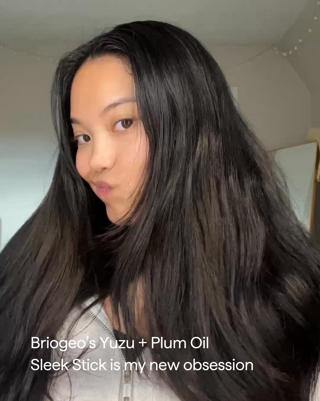Smooth frizz with Style + Treat Sleek Stick—a high-performance styler with naturally derived ingredients for 24-hour hold.